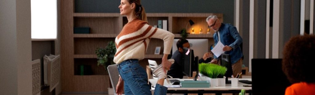 mujer estirándose en la oficina